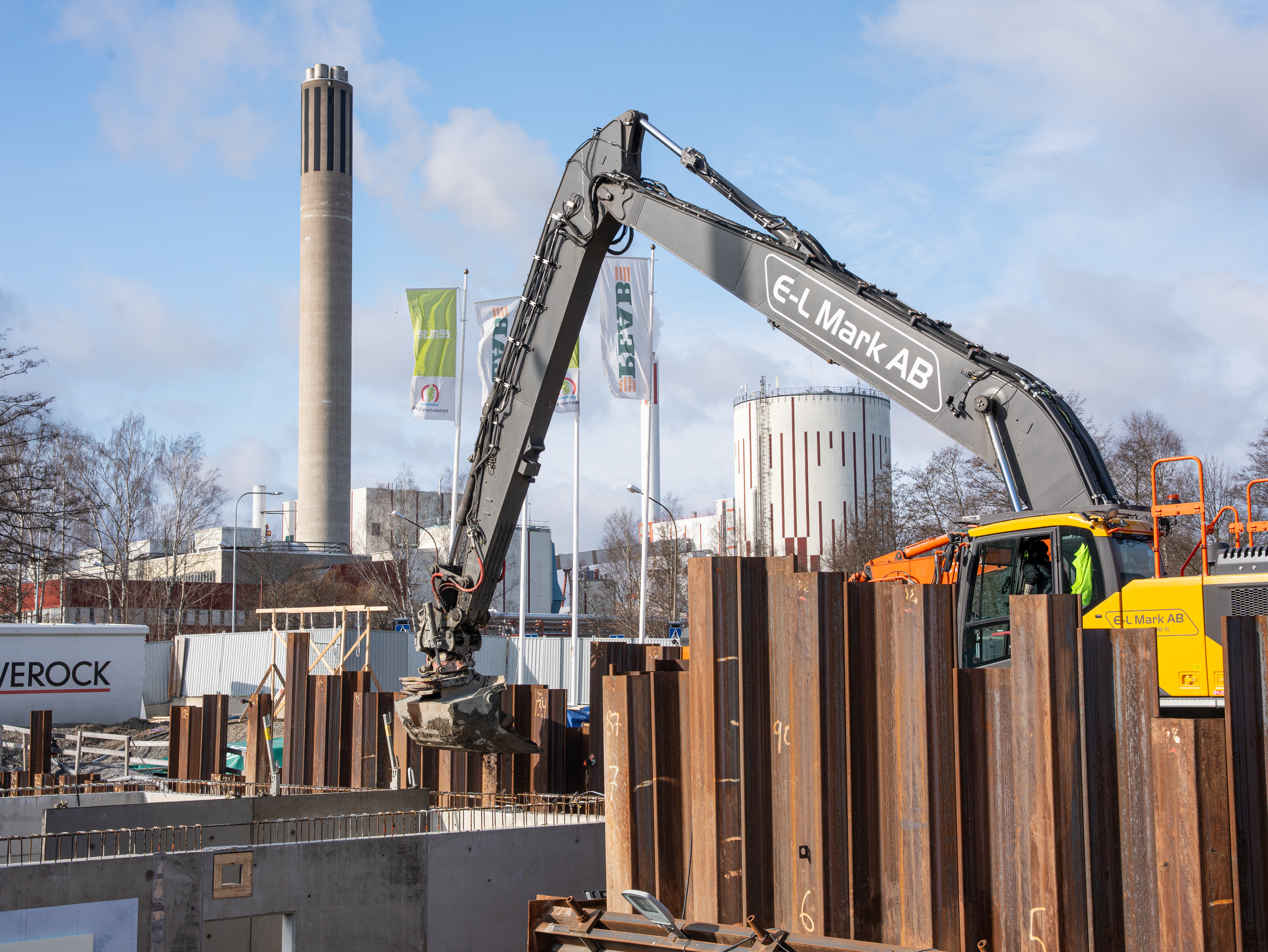 Grävmaskin fyller på med material runt pumpstationen.