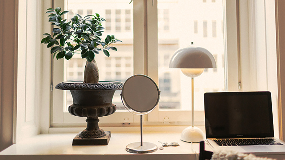 Lägenhetsfönster som arbetsplats med laptop.