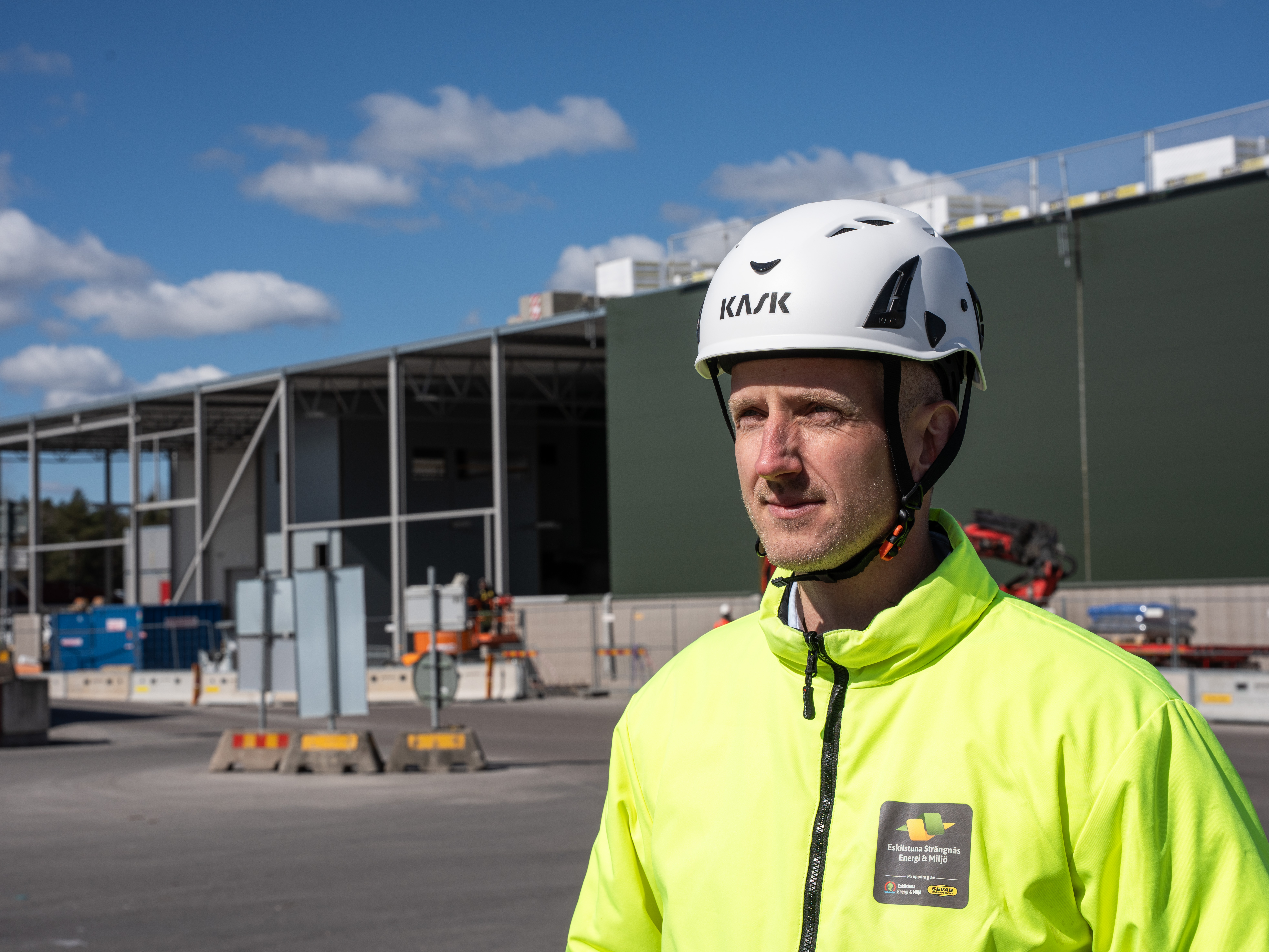 Kent Briby framför ombyggnationen i varselkläder och skyddshjälm